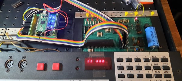 A Pi Pico on a breakout board inside a Busch 2090 educational computer