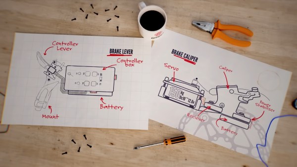Two pieces of paper on a table with a pair of pliers, a screwdriver, and a cup of what is probably coffee or tea. The sheets show a diagram of a bicycle handlebar on one side with a labeled "controller box, controller lever, mount, and battery." The other sheet shows a side view of a 150kg servo mounted on a plate that runs over to a brake caliper with a battery, receiver, and power stabilizer. These parts are also labeled in red text.