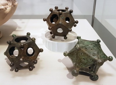 Two ancient Roman bronze dodecahedrons and an icosahedron (3rd c. AD) in the Rheinisches Landesmuseum in Bonn, Germany. (Credit: Kleon3, Wikimedia)