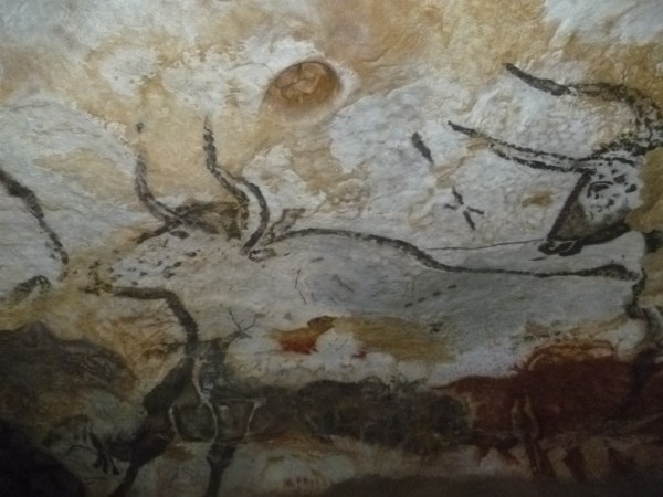 An image of a cave drawing of horned cow. There is another one coming up behind it as well. There are four dots as described by the researchers on the main cow's back.