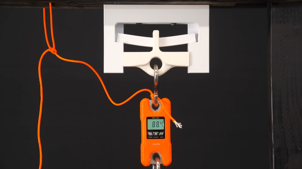 3D printed test jig to determine the yield point of a centrally loaded 3D printed beam.