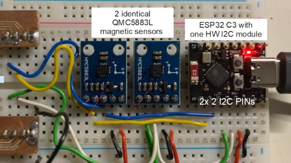 A breadboard showing a tiny ESP32 board and two HMC5883L sensors connected to it on different pins