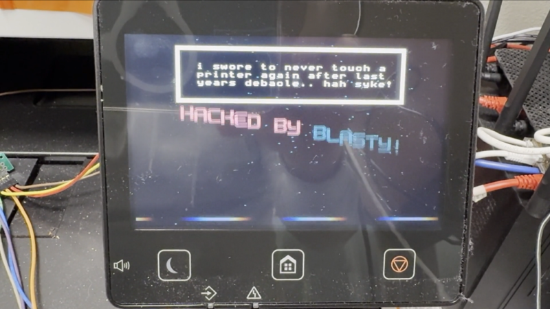 The printer's display with the exploit-loaded animation playing, saying "hacked by blasty" and a bunch more stuff