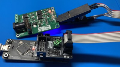 Showing the ESP-Prog-Adapter board plugged into the ESP-Prog adapter, wired to a SOIC clip, that then attaches to a PCB under test