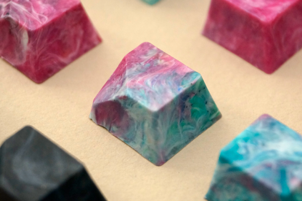 five 100% recycled keycaps, spaced out