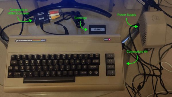 The experimental setup – a Commodore 64 is connected to a monitor through a composite video to HDMI converter, with the code cartridge inserted into the expansion port.