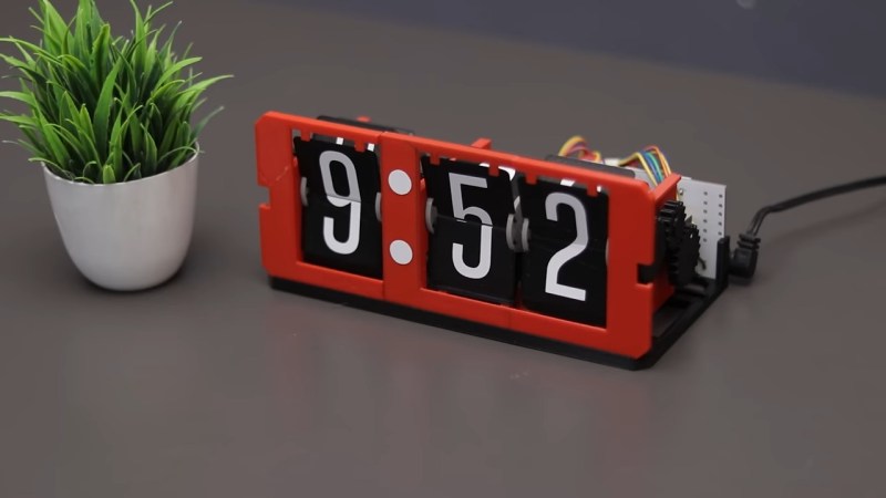 A DIY split-flap clock in red, black, and white.
