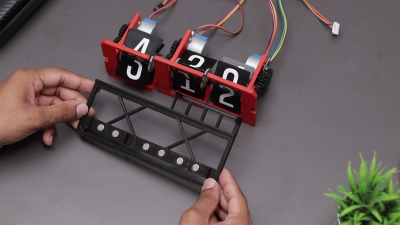 A DIY split-flap clock and its magnetic base.