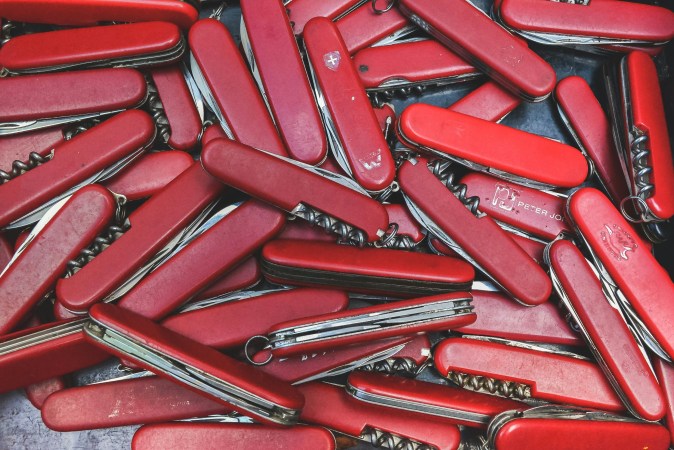 A pile of red Swiss Army knives, probably collected by TSA.