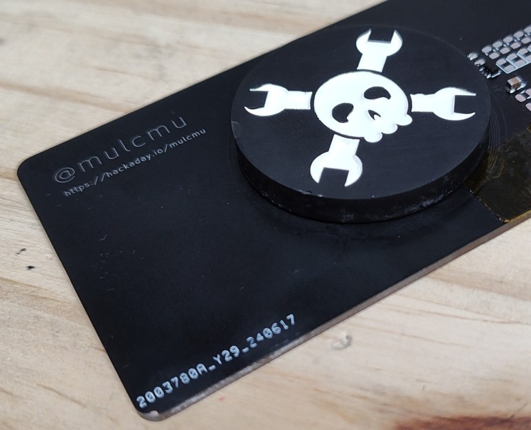 A business-card-sized fidget spinner with the Hackaday logo.