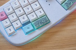 Up close on the spacebar of a Le Chiffre 3D-printed small keyboard with mint chocolate chip space bars and a Ring Pop knob.
