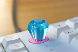 Up close on the Ring Pop knob of a Le Chiffre 3D-printed small keyboard with mint chocolate chip space bars and a Ring Pop knob.