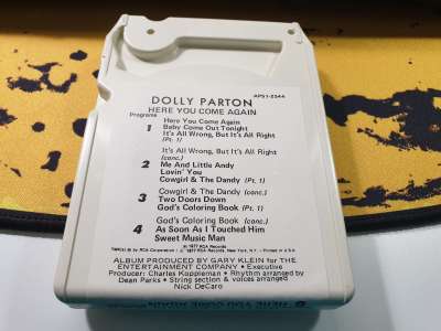 A copy of Dolly Parton's Here You Come Again on 8-track, darlin'.