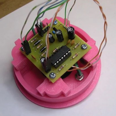 The guts of the doorbell alert in a pink 3D-printed enclosure.