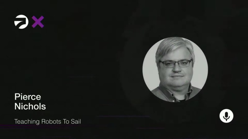 An image of a man in glasses in a circle placed on a black background. The title "Pierce Nichols: Teaching Robots to Sail" is on white lettering in the bottom left corner.