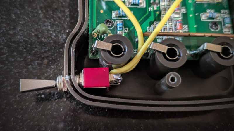 Insides of a multimeter, improved with a custom backlight switch.