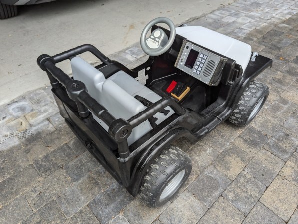 A tricked-out kids' Jeep in black and silver.