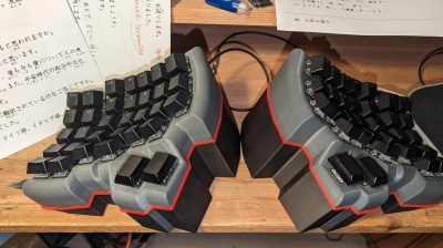 A Dactyl-esque ergonomic split keyboard with an extra wedge to the bases.