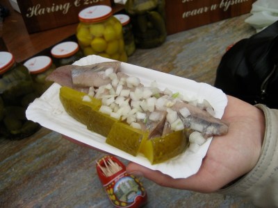 Dutch haring met uitjes en zuur, salted raw herring with chopped onions and pickles. Trust me, it's rather good.