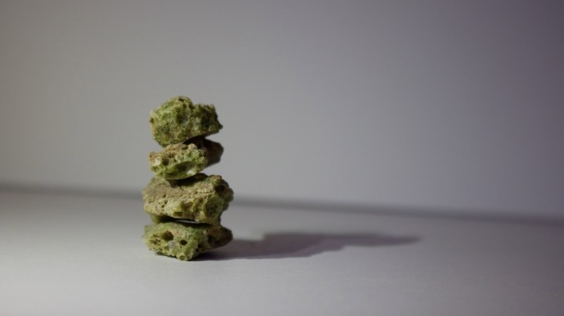 A stack of four bottle-green Trinitite samples. 