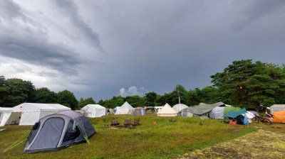 A hacker campsite against a dramatic cloudy sky