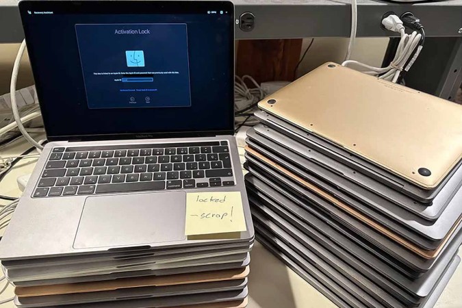 A stack of Activation Locked MacBooks destined for the shredder in refurbisher [John Bumstead]’s workshop.