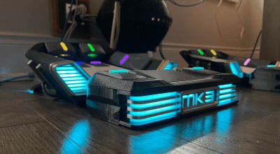 A couple of very cool foot pedal keyboards on a hardwood floor.