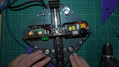 Overhead photo of [James]' hands assembling the Lemontron Portable 3D printer