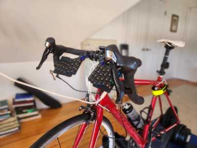 A split keyboard attached to a stationary bicycle.