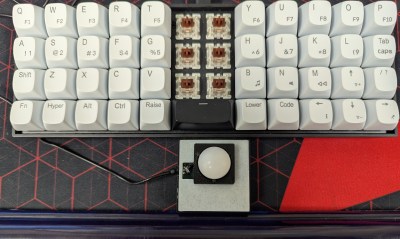 A split keyboard with a DIY trackball beneath the Space bar. 