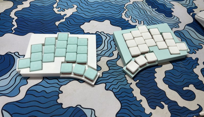 A Totem split keyboard on a nice blue-toned desk mat.