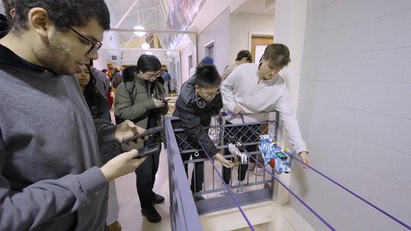 students overlooking their rope-traversing robots