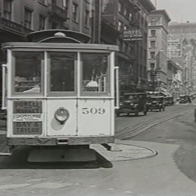 San Francisco cable car making its way through traffic. Early 20th century.