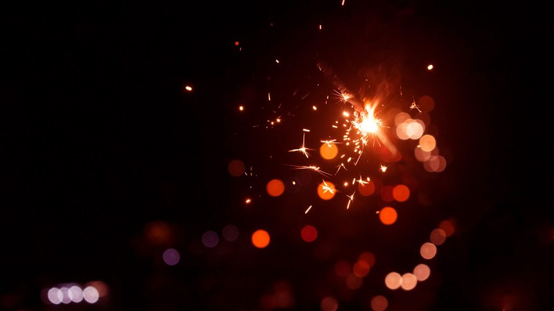 Bokeh photo of red light particles in the dark