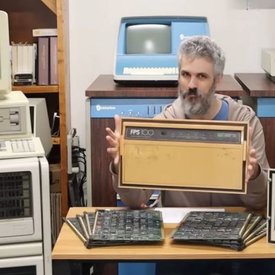 David Lovett of Usagi Electric fame sitting among his FPS minisupercomputer hardware. (Credit: David Lovett, YouTube)