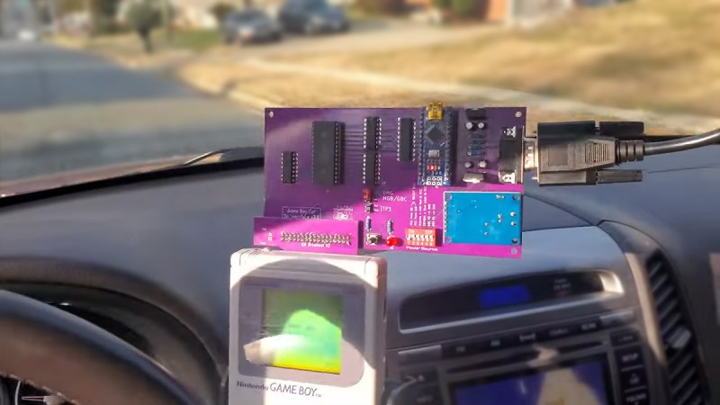 Game boy with custom cartridge mounted on car dashboard