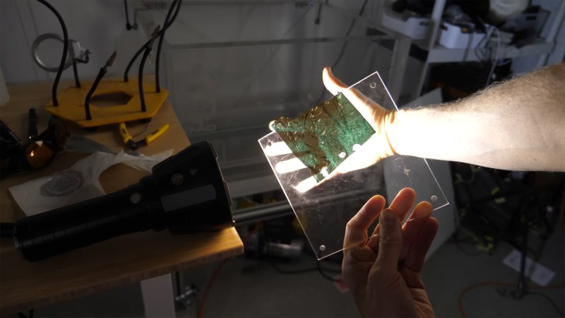 Flashlight shining through gold leaf on glass