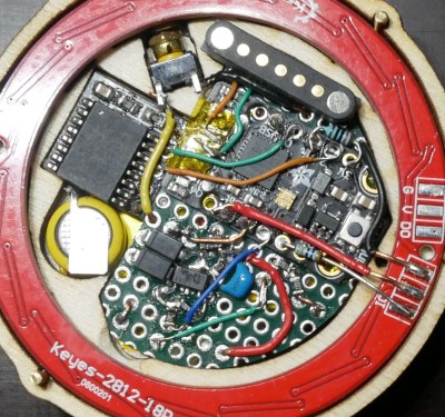 The guts of a pocket watch with glowing Roman numerals.