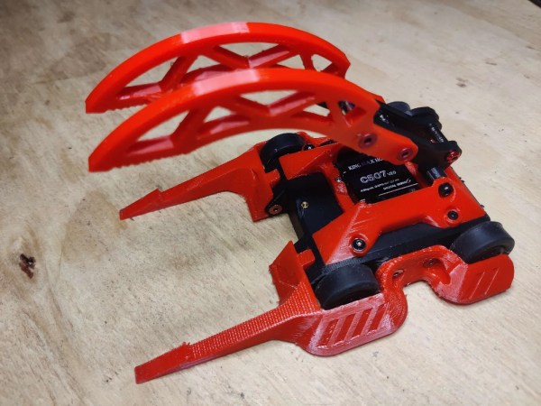 Red and black grabber combat robot