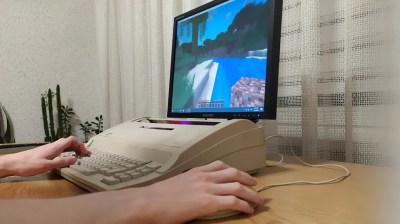 A sleek typewriter with a monitor and a mouse.