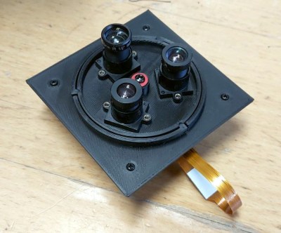 A 3d-printed module featuring three M12 lenses on a rotatable turret.