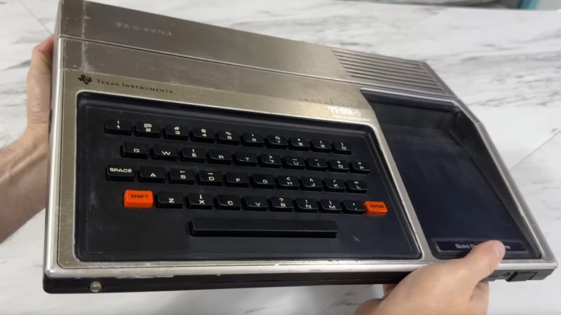 Hands holding a TI-99/4A.