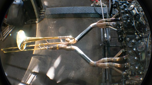 Two four-cylinder engines mechanically linked and exhausting into a trombone.