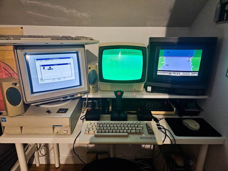 From left to right: an IBM PS/1, a Commodore64, and another vintage computer. 