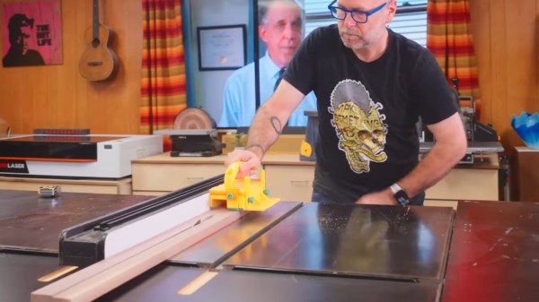 A man cutting wood with a circular bench saw