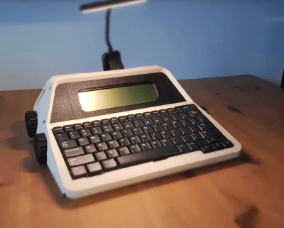 An AlphaSmart NEO in a 3D-printed, typewriter-esque enclosure, complete with big knobs.