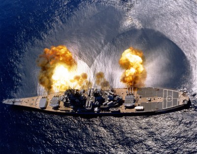 USS Iowa (BB-61) Fires a full broadside of nine 16/50 and six 5/38 guns during a target exercise near Vieques Island, Puerto Rico, 1 July 1984. Photographed by PHAN J. Alan Elliott. Note concussion effects on the water surface, and 16-inch gun barrels in varying degrees of recoil. Official U.S. Navy Photograph, from the the Department of Defense Still Media Collection.