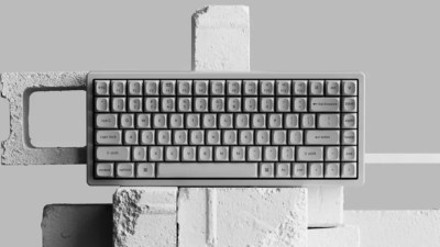 A black and white image of a concrete keyboard sitting on artfully-arranged cinder blocks.