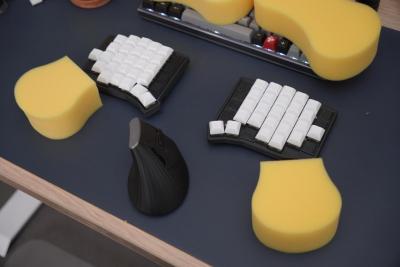 A split keyboard with a large sponge cut in half and employed as palm rests.