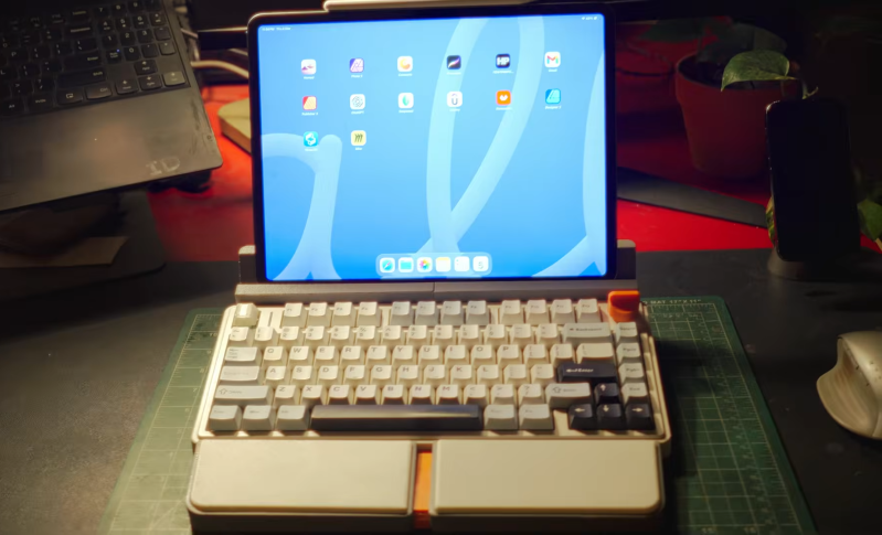 A mechanical keyboard, transformed to look like a retro laptop with an ipad for a screen